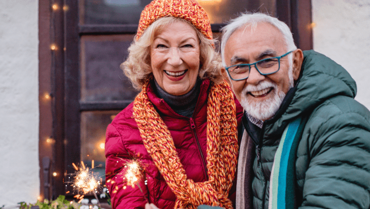 an elderly couple with a Christmas light 