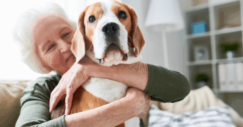 a senior lady kissing and hugging her dog